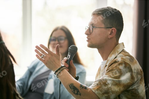 Preview: Young Man Speaking Into Microphone At Conference Event