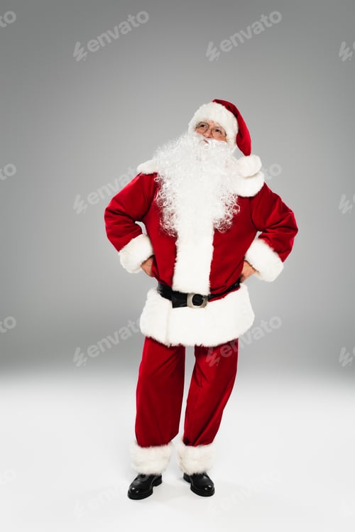 Preview: Pensive santa claus in costume looking away on grey background