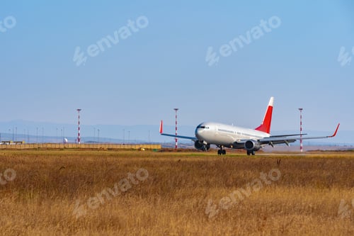 Preview: Passenger plane taking off from runway at airport on sunny day