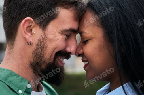 Preview: A close-up of an interracial couple sharing an intimate moment
