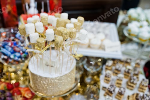Preview: Different swets and cup cakes at wedding reception.