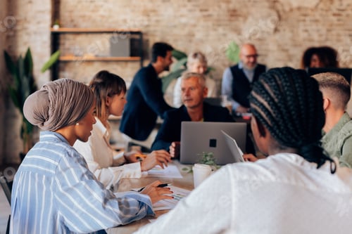 Preview: multi-ethnic crowd people sitting at work brainstorming and discussing strategies