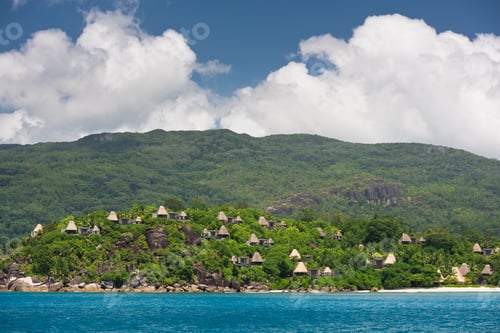 Preview: View of Seychelles coastline with houses in the forest