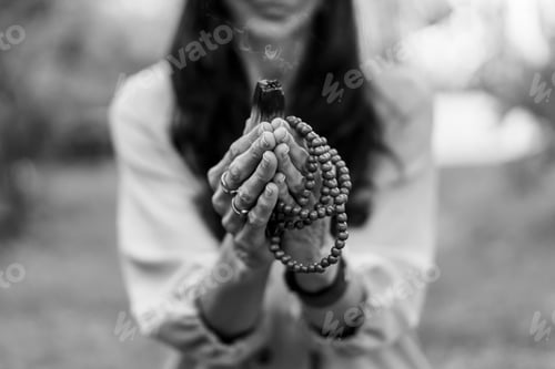 Preview: Close-up of a japa mala and a burning palo santo or holy sacred tree stick held by a woman.
