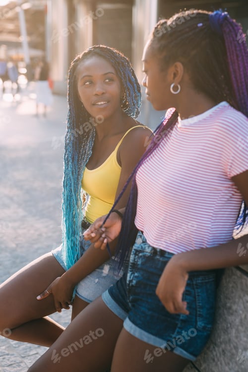 Preview: Young Women Relaxing and Chatting in City Setting
