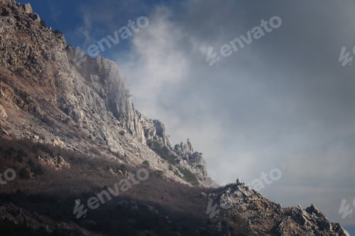 Preview: Slope mountain with scattered stones on a background of blue sky