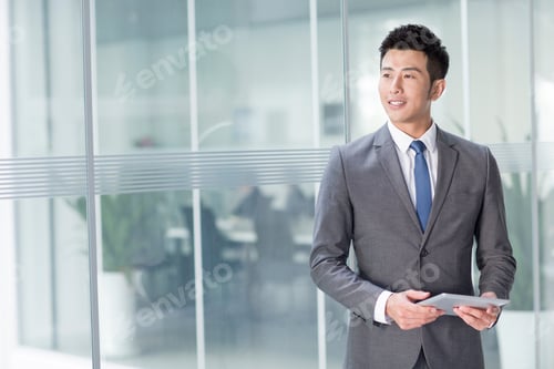 Preview: Young businessman with digital tablet