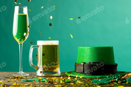 Preview: Image of beer and champagne glasses, green hat and copy space on green background
