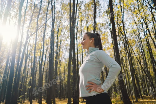 Preview: Girl doing fitness in nature on a sunny autumn forest