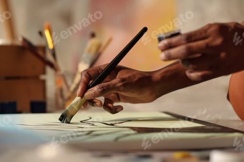 Preview: Painter Creating Artwork With Brushes Holding Paint