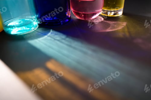 Preview: Multicolor glass bottles and reflections in harsh light