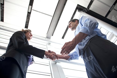 Preview: Businessman and woman meeting in the lobby of a conference centre.