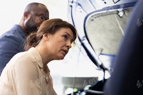 Preview: Agent ensuring clients satisfaction, showing parts used inside car