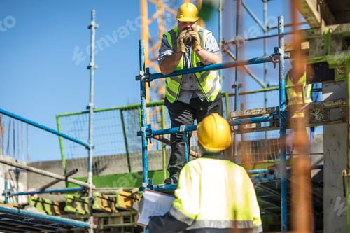 Preview: Construction workers in discussion on building site