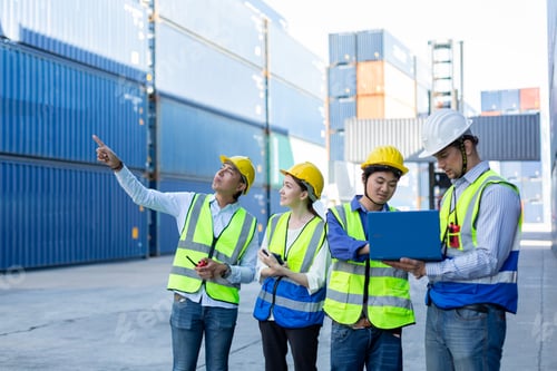 Preview: Teamwork engineer technician and foreman and partner wearing safety helmet in cargo
