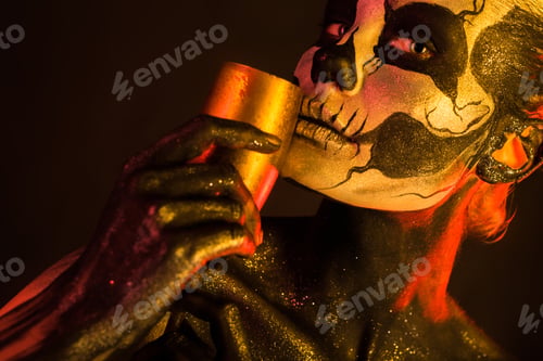 Preview: Pretty girl with skeleton makeup holds glass