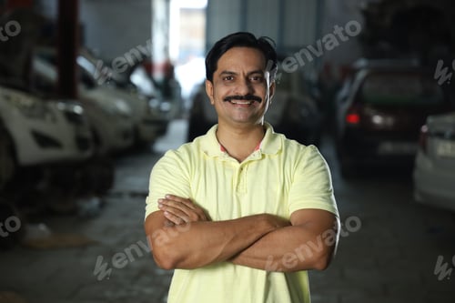 Preview: Shallow focus photo of a happy Indian client in a motor shop