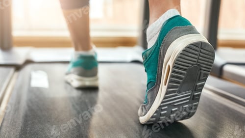 Preview: Cardio workout. Cropped photo of woman in sports shoes running on treadmill at gym. Sport and