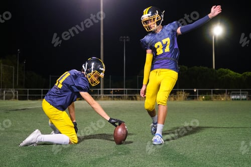 Preview: American football players practicing field goal kicking at night