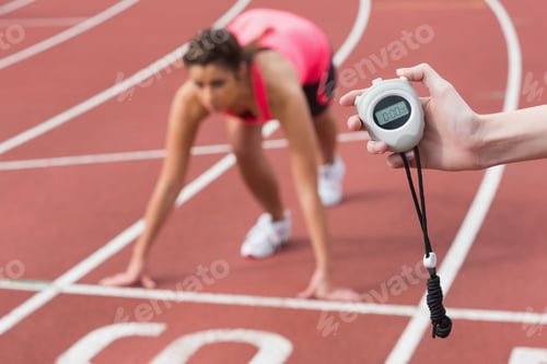 Preview: Close-Up Of A Hand Timing A Blurred Young Woman'S Run On The Running Track