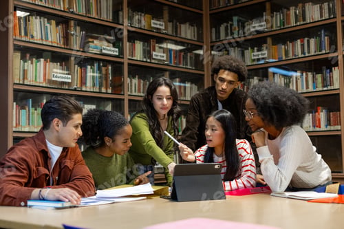 Diverse students collaborating on project in library