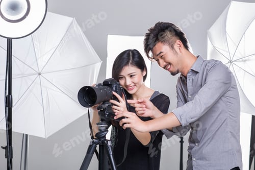 Preview: Two photographers working in studio