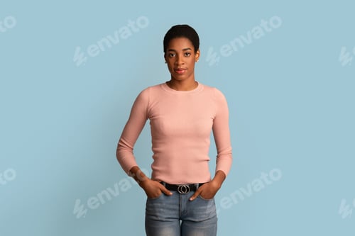 Preview: Portrait Of Young Beautiful African American Woman Posing Over Blue Studio Background
