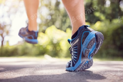 Preview: Feet of runner running or jogging on a road in summer