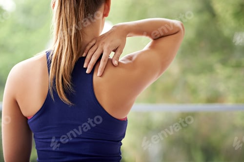 Preview: Stretching her triceps. Rearview shot of a sporty woman practicing yoga at home.