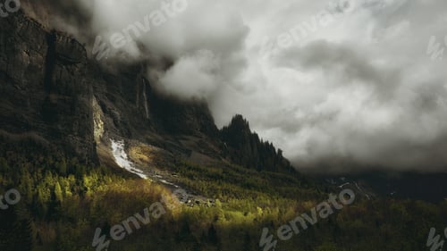Preview: Tall mountain covered with white thick clouds