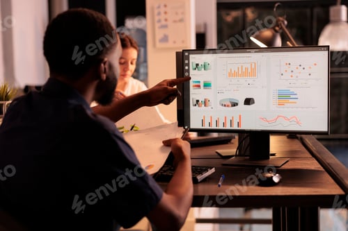 Preview: Analyst looking at report data on computer, holding clipboard