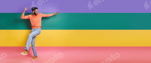 Preview: Full length of playful African man dancing against colorful background
