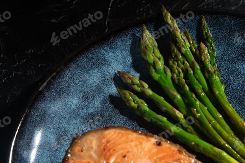 Preview: Fried asparagus on a dark background. Dish close-up.