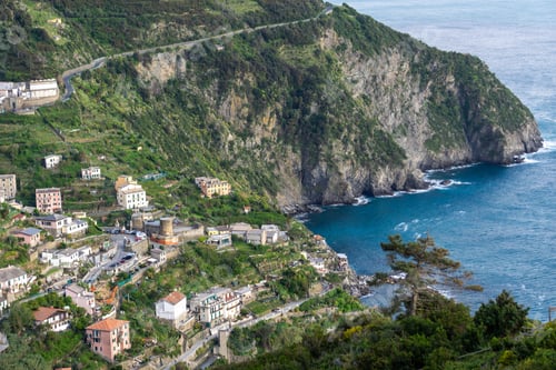 Preview: Scenic view of Monterosso al Mare beach with vibrant blue water and historic buildings in Italy