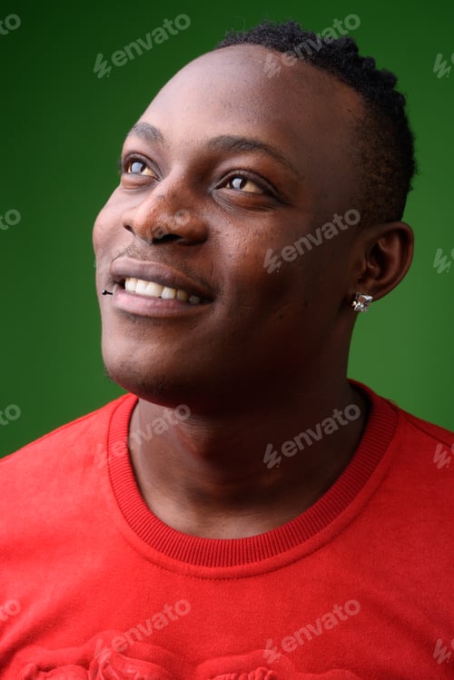 Preview: Young handsome African man from Kenya against green background