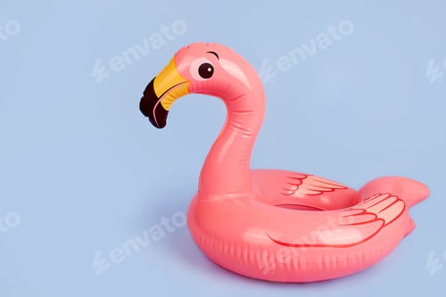 Preview: Inflatable flamingo on a blue background, a beach toy.