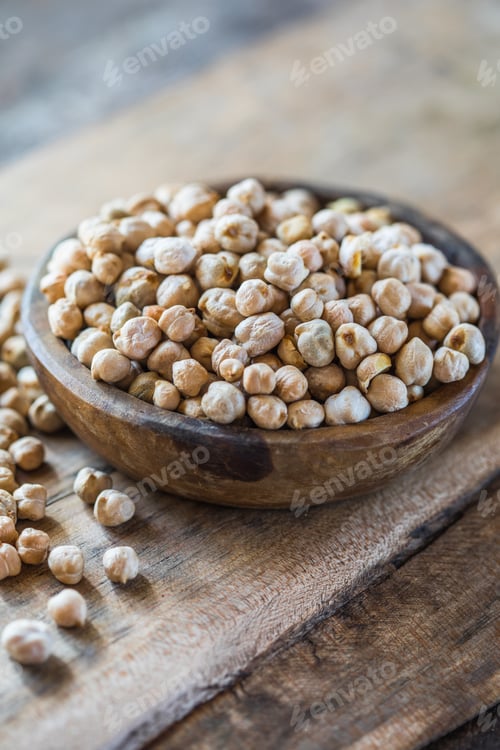 Preview: Raw chickpeas in a wooden bowl. Legume dietary fibers and vegetable protein for healthy eating.