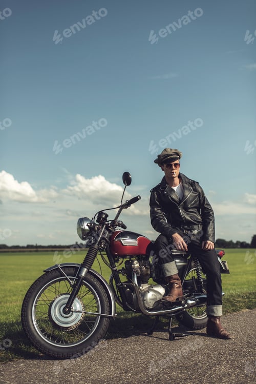 Preview: Vintage Motorcyclist Having A Break Along Rural Road In Summer.
