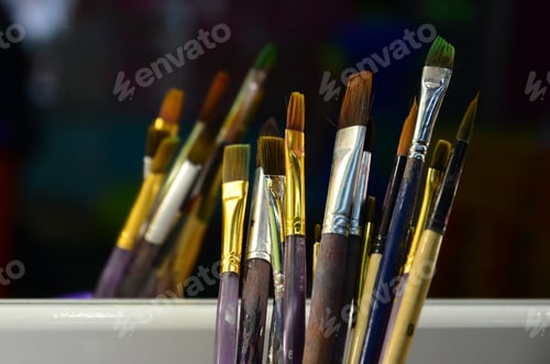 Preview: Art paint brushes in cup are located in the children's entertainment hall at the mirror