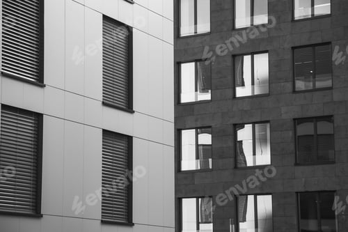 Preview: Greyscale shot of the windows of the buildings captured during the daytime