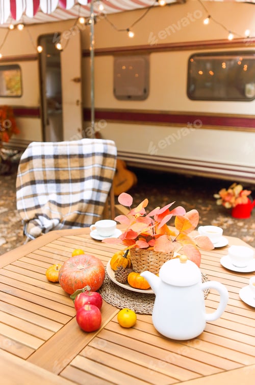 Preview: Table and chairs outside trailer in nature