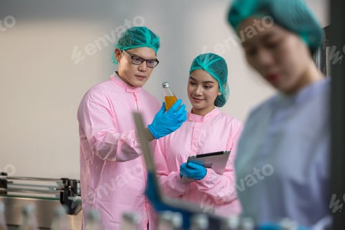 Preview: Worker Checking quality or checking stock of glass bottle in beverage factory.