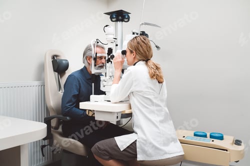 Preview: Female doctor and senior patient in ophthalmology clinic. Patient at doctor for eye examination.