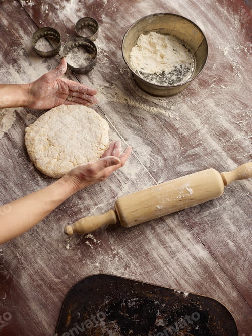 Preview: Overhead view of womans hands shaping scone dough