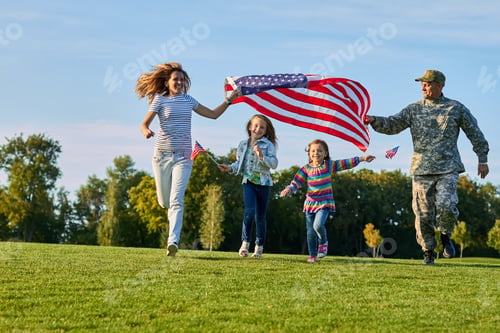 Preview: Shot of patriotic family running with flag.