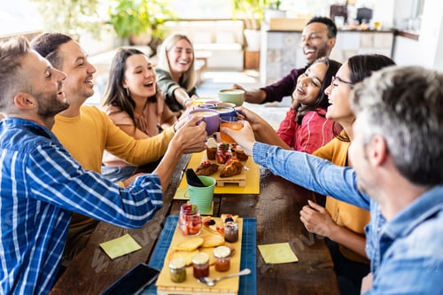 Preview: Smiling multiracial group of young people having breakfast