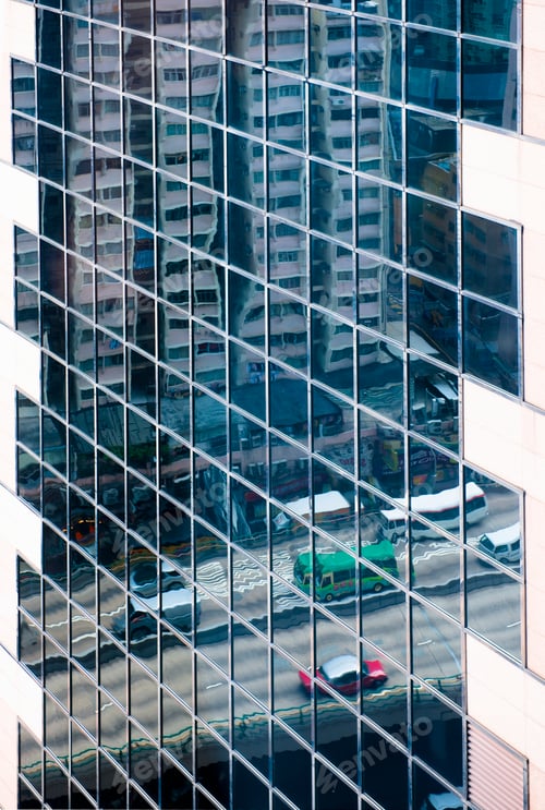 Preview: Reflection of city traffic in high rise building.