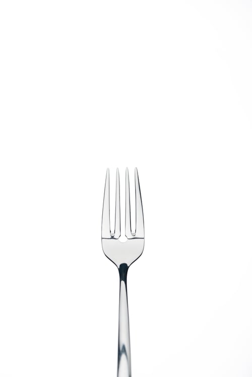 Preview: four-prong metal shiny fork isolated on white