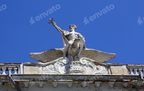 Preview: Statue on the top of an old building against the blue sky