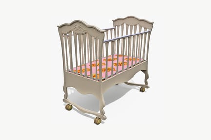 Preview: Ornate white wooden crib with patterned mattress